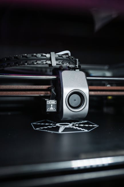 Detailed close-up view of a modern 3D printer in operation, focusing on the printhead.